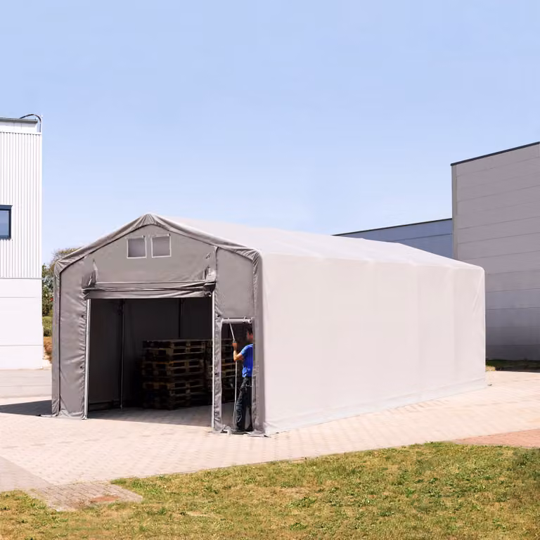 Carpa industrial TOOLPORT de 5 x 10 m con altura lateral de 3,0 m, puerta levadiza y estructura de acero galvanizado en color gris
