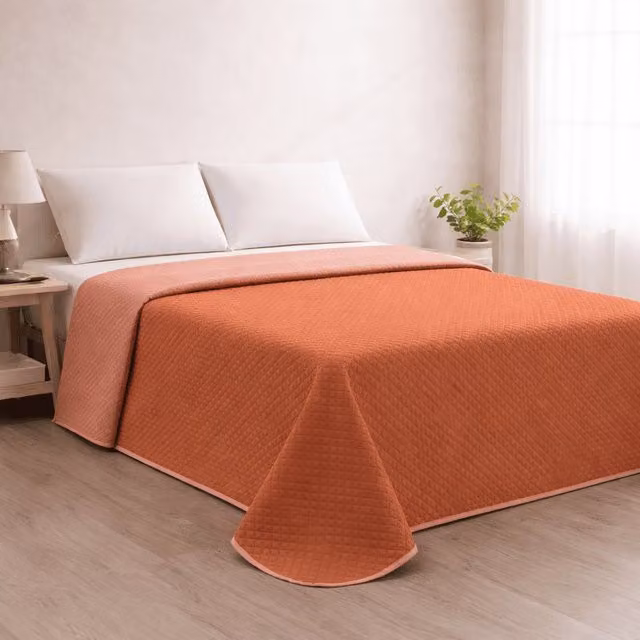 Colcha reversible acolchada Donegal Collections en color teja y coral para cama de 280 cm