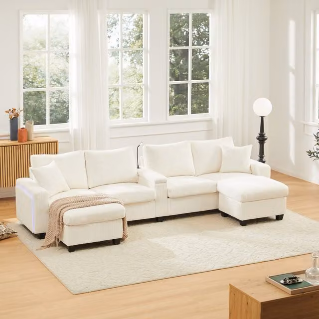 Sofá en U DREAMMESPACE de terciopelo acanalado con iluminación LED, puertos USB/Type-C y 2 pufs, color beige, An/P/Al: 334 x 128,5 x 81 cm