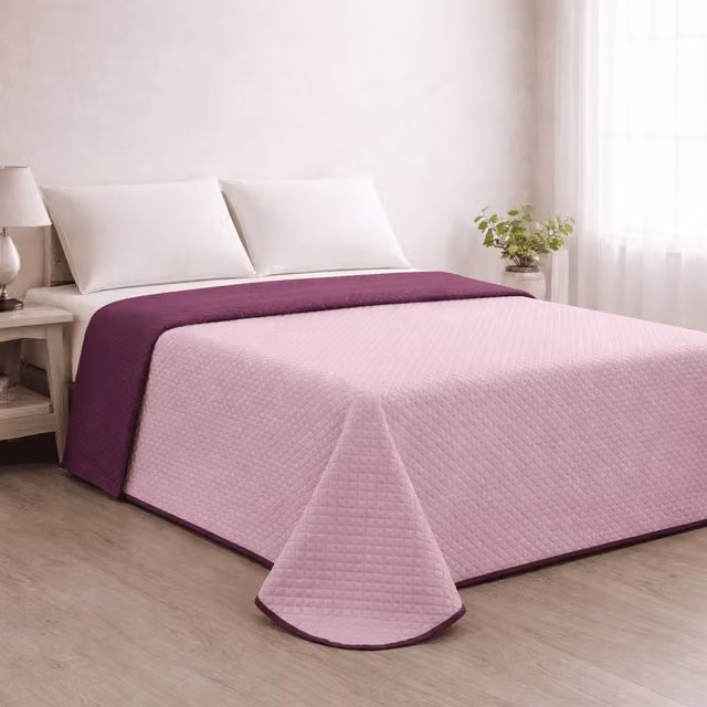 Colcha reversible acolchada Donegal Collections en colores salmón y berenjena para cama de 105 cm