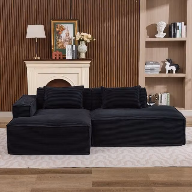 Sofá de tela de pana KELLANY en color negro con diseño en L y dos cojines, Ancho: 235 cm