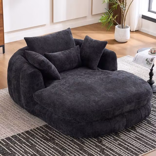 Tumbona de chenilla HAUSS SPOLE en color negro con diseño moderno en forma de L, asiento profundo tapizado con cojines incluidos para tu salón o dormitorio