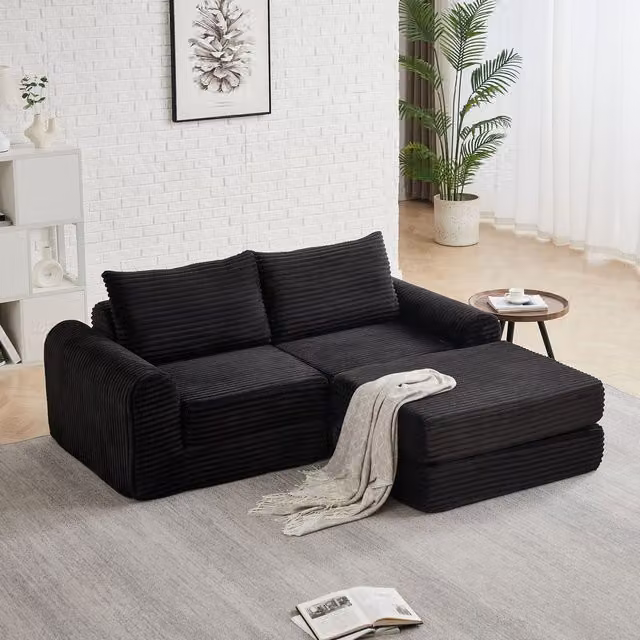 Sofá cama modular de pana KELLANY en color negro con reposapiés extraíble y dos cojines para tu salón