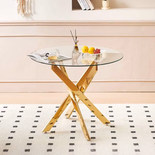 Mesa de comedor redonda MODFU con tablero de cristal templado transparente y patas de metal en color dorado de estilo moderno, An/P/Al: 80 x 80 x 75 cm