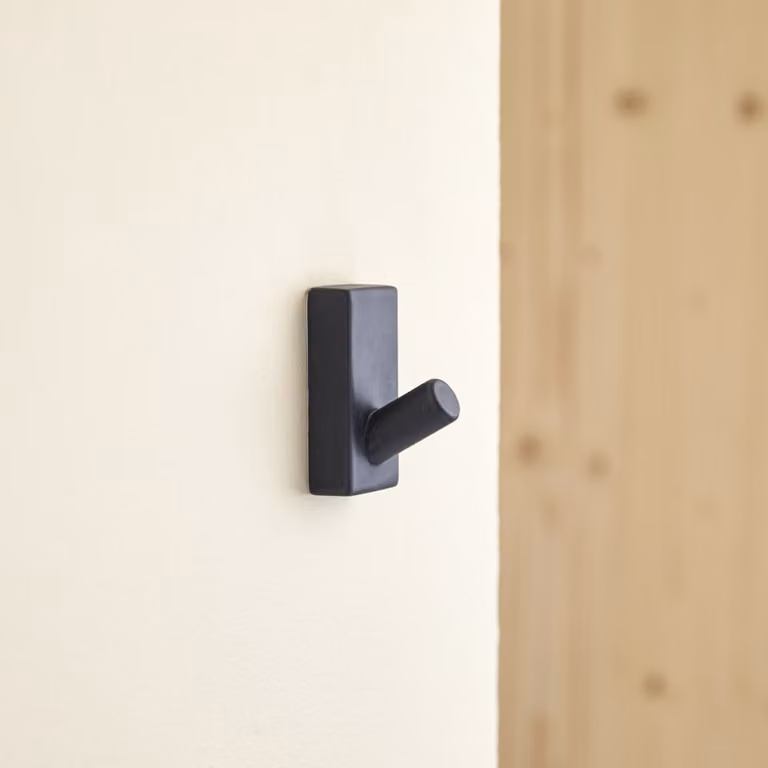 Colgador de pared de piedra Tikamoon en color negro con acabado de terrazo y diseño minimalista rectangular